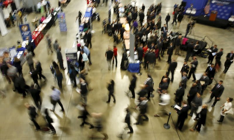 FILE PHOTO: Job seekers break out to visit employment personnel at "Hiring Our Heroes" military job fair in Washington