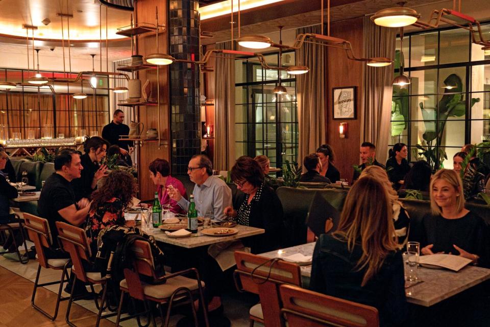 Diners sitting in the warm, dimly-lit dining room of Ladyhawk in West Hollywood.