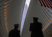 <p>Two members of the New York City fire department look towards One World Trade Center through the open ceiling of the Oculus, part of the World Trade Center transportation hub in New York, Tuesday, Sept. 11, 2018, the anniversary of 9/11 terrorist attacks. The transit hall ceiling window was opened just before 10:28 a.m., marking the moment that the North Tower of the World Trade Center collapsed on September 11, 2001. (Photo: Craig Ruttle/AP) </p>