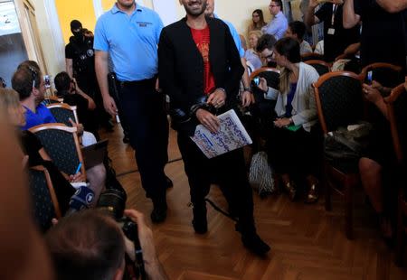 A defendant arrives to the court room, ahead of a trial of men charged with causing the death of 71 migrants who suffocated in a lorry found beside an Austrian motorway in 2015, in Kecskemet, Hungary, June 21, 2017. REUTERS/Bernadett Szabo