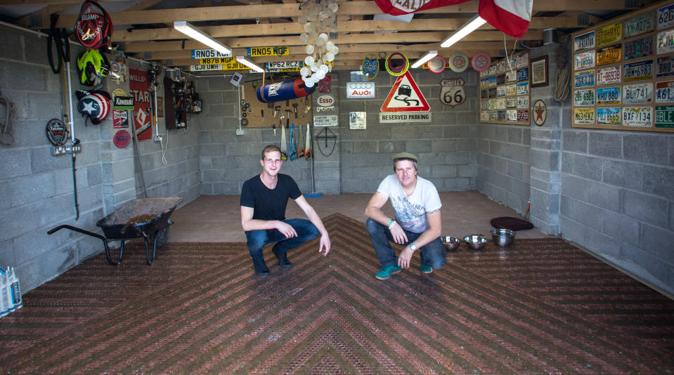 Dominic and Jon Lowe are spending 10 hours a week sticking 2p coins to the garage floor (Francis Hawkins/SWNS.com)