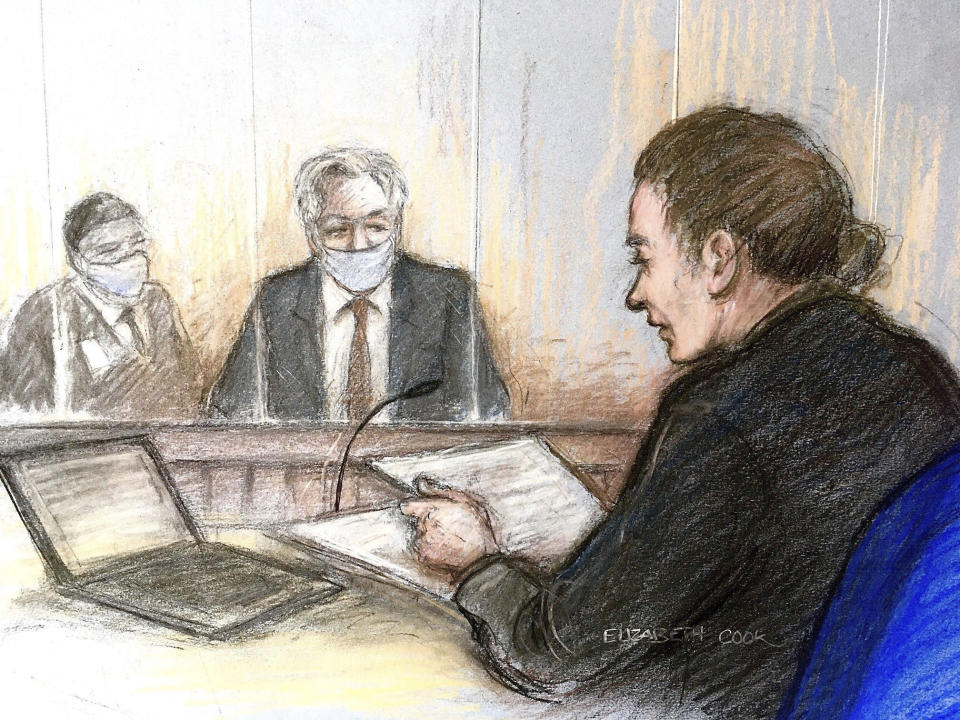 Court artist sketch by Elizabeth Cook showing Julian Assange, centre, appearing at Westminster Magistrates' Court where the WikiLeaks founder was refused bail, in London, Wednesday Jan. 6, 2021. The United States authorities are appealing against a recent court decision to block the extradition of Assange, and WikiLeaks said Wednesday the denial of bail would be appealed. (Elizabeth Cook/PA via AP)