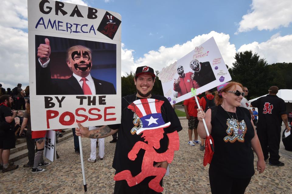 <p>Fans of the US rap group Insane Clown Posse, known as Juggalos, hold placards mocking US President Donald Trump during a protest on Sept. 16, 2017 near the Lincoln Memorial in Washington against a 2011 FBI decision to classify their movement as a gang. (Photo: Paul J. Richards/AFP/Getty Images) </p>