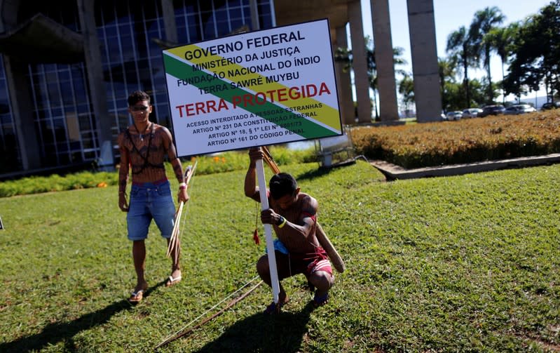 FILE PHOTO: Members of indigenous Munduruku tribe place a plaque as they protest against the construction of Tapajos hydroelectric project in their land in front the Ministry of Justice in Brasilia