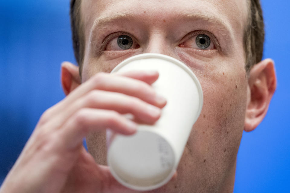 FILE - In this April 11, 2018, file photo, Facebook CEO Mark Zuckerberg takes a drink of water as he testifies before a House Energy and Commerce hearing on Capitol Hill in Washington. Reports of hateful and violent speech on Facebook poured in on the night of May 28 after President Donald Trump hit send on a social media post warning that looters who joined protests following Floyd's death last year would be shot, according to internal Facebook documents shared with The Associated Press. (AP Photo/Andrew Harnik, File)