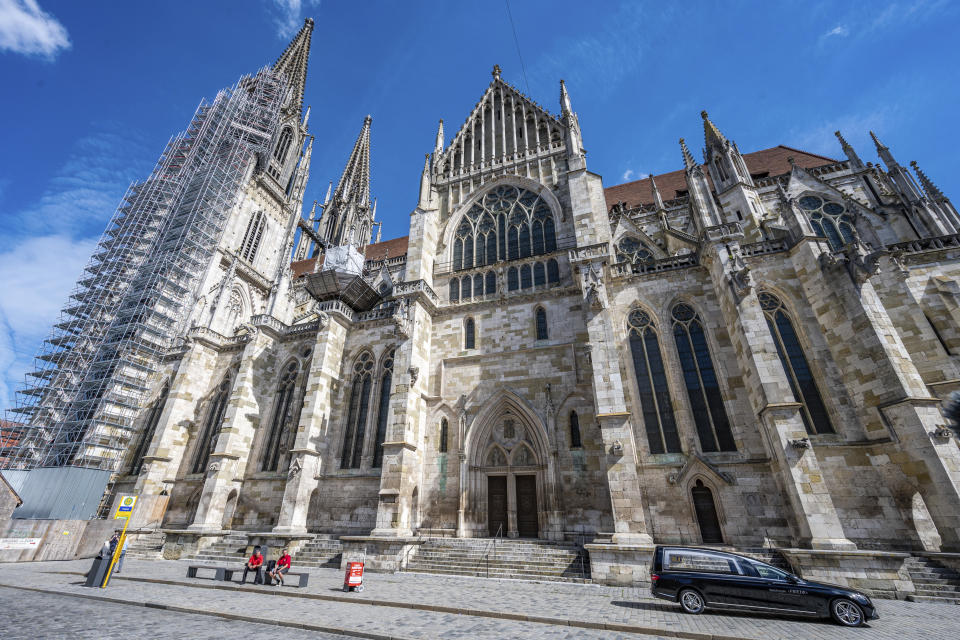 A hearse parks during the funeral service for Priest Georg Ratzinger in front of St. Peter's Cathedral in Regensburg, Germany, Wednesday, July 8, 2020. The elder brother of the emeritus Pope Benedict XVI had died on July 1 at the age of 96 years. (Armin Weigel/dpa via AP)