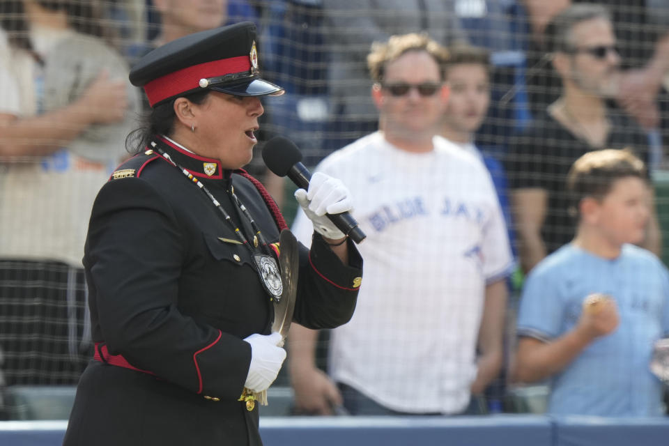 Sgt. Chantal Larocque sings "O Canada'" as part of the National Truth and Reconciliation Day ceremony before a baseball game between the Toronto Blue Jays and the Tampa Bay Rays in Toronto, Saturday, Sept. 30, 2023. (Frank Gunn/The Canadian Press via AP)