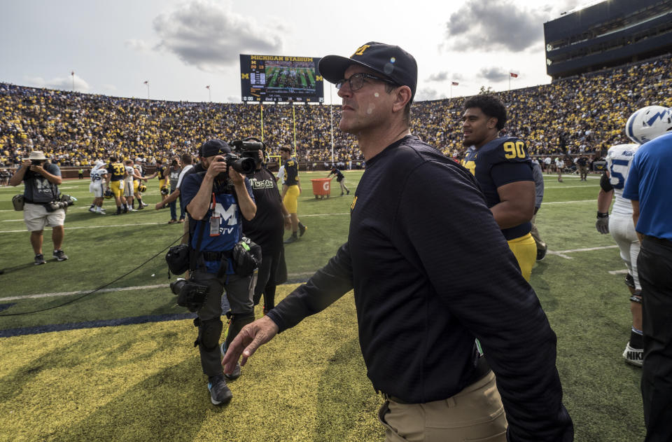 Michigan head coach Jim Harbaugh walks off the field after an NCAA college football game against Air Force in Ann Arbor, Mich., Saturday, Sept. 16, 2017. Michigan won 29-13. (AP Photo/Tony Ding)