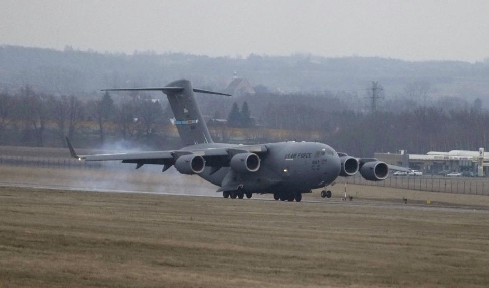 A U.S. Army transport plane landing at the Rzeszow-Jasionka airport in southeastern Poland on Sunday, Feb. 6, 2022, bringing from Fort Bragg troops and equipment of the 82nd Airborne Division. Additional U.S. troops are arriving in Poland after President Joe Biden ordered the deployment of 1,700 soldiers here amid fears of a Russian invasion of Ukraine. Some 4,000 U.S. troops have been stationed in Poland since 2017. (AP Photo/Czarek Sokolowski)