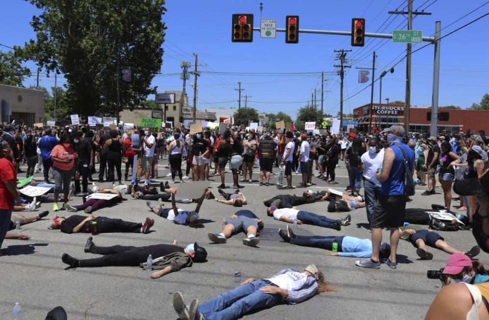 People lie down on Interstate 44 in Tulsa during a demonstration sparked by the death of George Floyd.