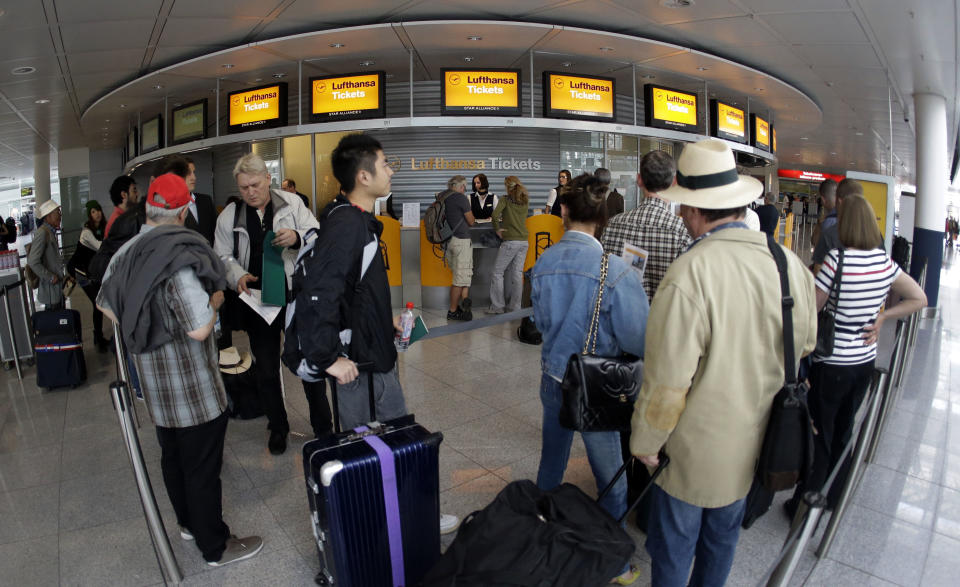 Passengers wait in front of Lufthansa counters as flight attendants of German Lufthansa airline went on an 24-hour-strike for higher wages at the airport in Munich, southern Germany, on Friday, Sept. 7, 2012. (AP Photo/Matthias Schrader)