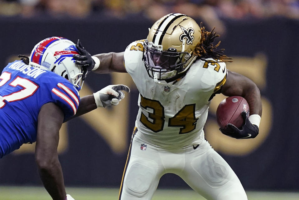 New Orleans Saints running back Tony Jones (34) carries against Buffalo Bills defensive end Mario Addison in the first half of an NFL football game in New Orleans, Thursday, Nov. 25, 2021. (AP Photo/Derick Hingle)