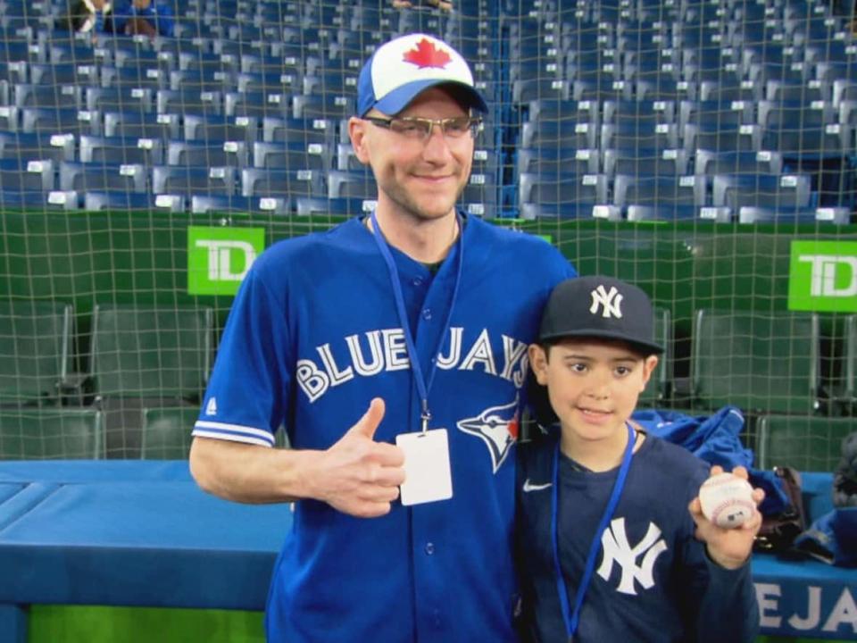 Michael Lanzillotta, left, snagged an Aaron Judge home run ball in Toronto Tuesday and handed it over to Derek Rodriguez, right, because he knew how much that would mean to a young fan.   (Grant Linton/CBC - image credit)