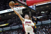 Miami Heat guard Tyler Herro, left shoots over Atlanta Hawks forward John Collins during the first half of Game 1 of an NBA basketball first-round playoff series, Sunday, April 17, 2022, in Miami. (AP Photo/Lynne Sladky)