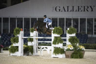 In this undated photo provided by KindMedia, Sophie Gochman on Carola BH rides in the FEI Hermes U25 Grand Prix night class during the Winter Equestrian Festival in Florida. Gochman wrote a recent blog that spelled out issues in show jumping, where she says white privilege and abundant wealth are the norm. It sparked a contentious debate within the equestrian world about how it deals with race, and how it is reacting to the calls for change that have come in the wake of George Floyd's death. (Annie Patterson/KindMedia via AP)