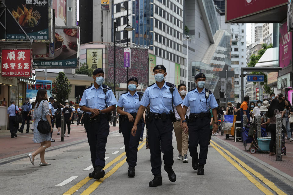 Police officers patrol near the Victoria Park in Hong Kong, Friday, June 4, 2021. Police arrested an organizer of Hong Kong's annual candlelight vigil remembering the deadly Tiananmen Square crackdown and warned people not to attend the banned event Friday as authorities mute China's last pro-democracy voices. In past years, tens of thousands of people gathered in Hong Kong's Victoria Park to honor those who died when China’s military put down student-led pro-democracy protests on June 4, 1989. Hundreds, if not thousands were killed. (AP Photo/Kin Cheung)