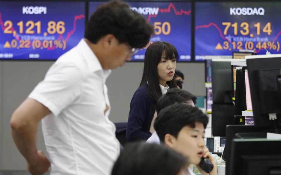 Currency traders work at the foreign exchange dealing room of the KEB Hana Bank headquarters in Seoul, South Korea, Wednesday, June 26, 2019. Asian shares were mostly lower Wednesday as investors awaited developments on the trade friction between the U.S. and China at the Group of 20 meeting of major economies in Japan later in the week. (AP Photo/Ahn Young-joon)