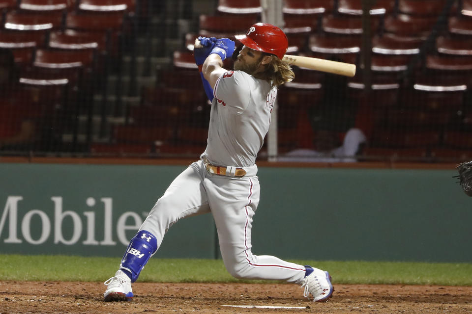 Philadelphia Phillies' Bryce Harper follows through on his three run home run against the Boston Red Sox during the sixth inning of a baseball game Tuesday, Aug. 18, 2020, at Fenway Park in Boston. (AP Photo/Winslow Townson)