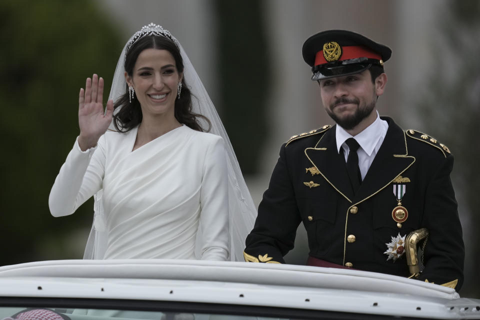 Jordan's Crown Prince Hussein and Saudi Rajwa Alseif wave to well-wishers during their wedding ceremonies in Amman, Jordan, Thursday, June 1, 2023. (AP Photo/Nasser Nasser)