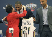 Willie Green gets a hug from New Orleans Pelicans Governor Gayle Benson after he was introduced as the new head coach for the New Orleans Pelicans NBA basketball team, in Metairie, La., Tuesday, July 27, 2021. At right is Pelicans General Manager Trajan Langdon. (AP Photo/Ted Jackson)