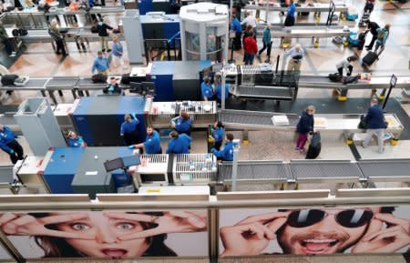 FILE PHOTO: TSA Security personnel wait for passengers at Denver International Airport outside Denver, Colorado U.S. on November 3, 2017.  REUTERS/Rick Wilking