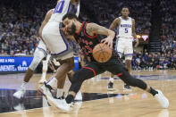 Toronto Raptors guard Fred VanVleet (23) drives to the basket past Sacramento Kings forward Harrison Barnes during the first quarter of an NBA basketball game in Sacramento, Calif., Wednesday, Jan. 25, 2023. (AP Photo/Randall Benton)