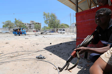 A Somali policeman holds position as al-Shabaab militia storms a government building in Mogadishu, Somalia March 23, 2019. REUTERS/Feisal Omar