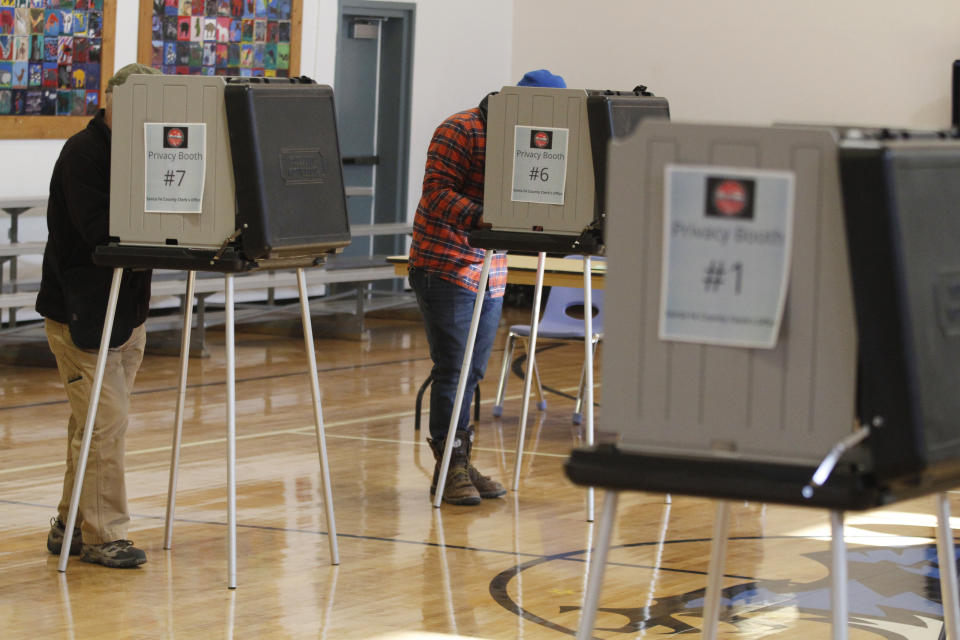 FILE - Voters fill out ballots at an elementary school in Tesuque, N.M., on Tuesday, Nov. 8, 2022. A federal judge has ruled, Tuesday, April 2, 2024, that New Mexico election regulators violated public disclosure provisions of the National Voter Registration Act in withholding voter rolls from a conservative group and its public online database. (AP Photo/Morgan Lee, File)