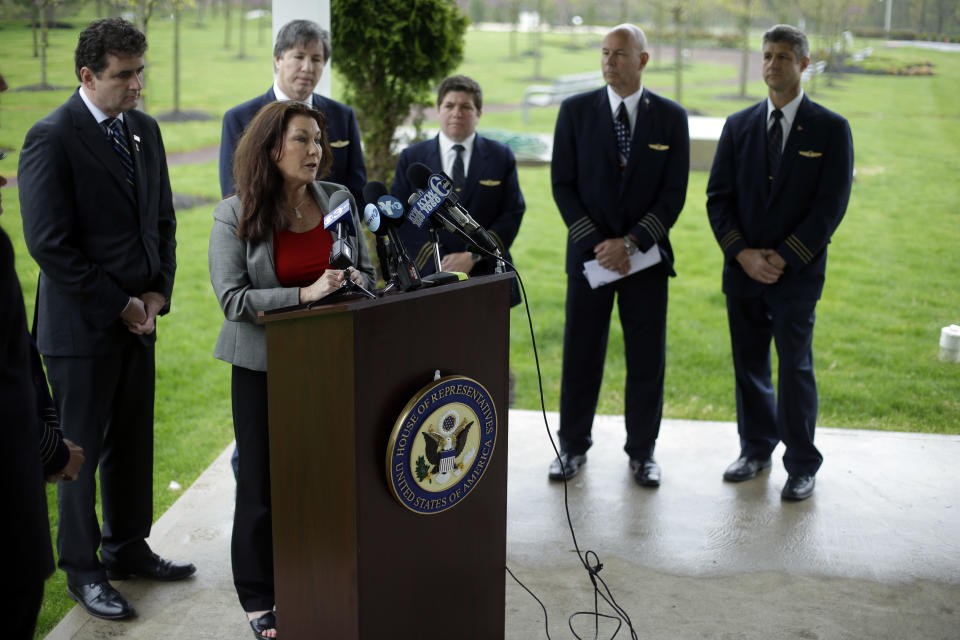 Rep. Mike Fitzpatrick, R-Pa., left, and airline pilots look on as Ellen Saracini, at podium, whose husband Victor was the captain of United Airlines Flight 175 that crashed into the World Trade Center on Sept. 11, 2001, speaks during a news conference at the at the Garden of Reflection memorial to local victims of the 9/11 terrorist attacks, Monday, April 29, 2013, in Yardley, Pa. Fitzpatrick proposed new legislation aimed at protecting airline passengers and pilots from the kind of terrorist attack upon the nation a dozen years ago. (AP Photo/Matt Rourke)