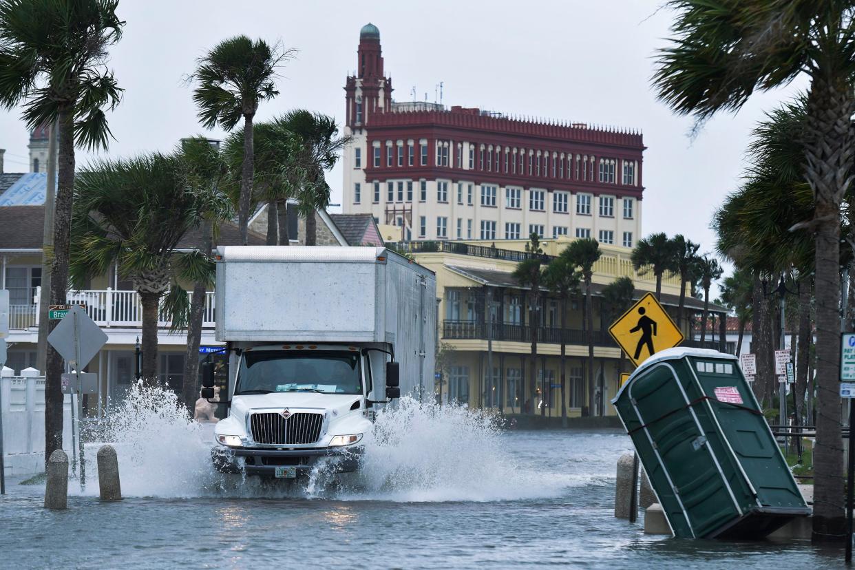 A truck moves down flooded Avenida Menendez in the in Saint Augustine's historic district Wednesday after storm driven high tides flooded low lying areas of the city.