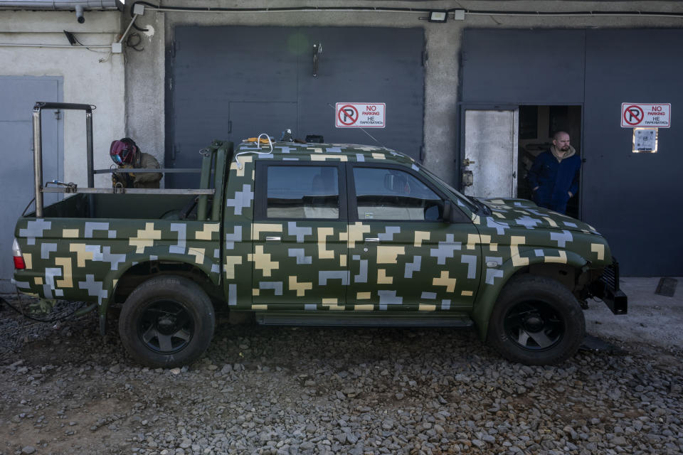 Car welder Ostap Datsenko, 31, works on a vehicle that will be sent to soldiers on the frontlines, at a welding workshop in Lviv, western Ukraine, Sunday, March 27, 2022. (AP Photo/Nariman El-Mofty)