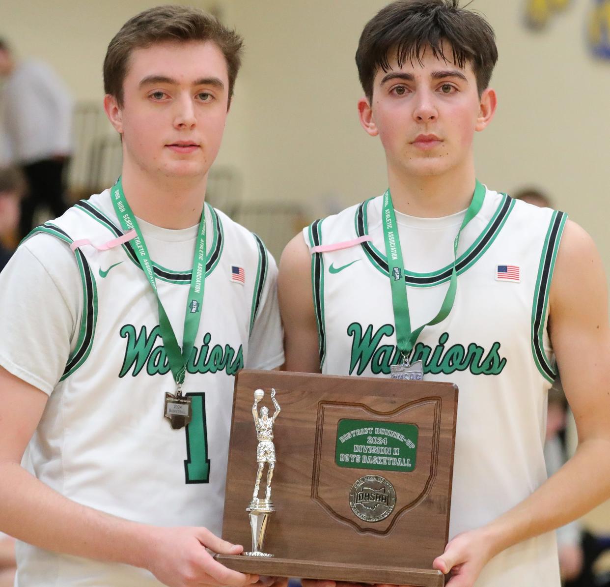 West Branch seniors Riley Hendershott, left, and Jaxon Robb hold the district runner-up trophy after a loss to Warrensville Heights, Saturday, March 9, 2024, at Chardon ND-CL.