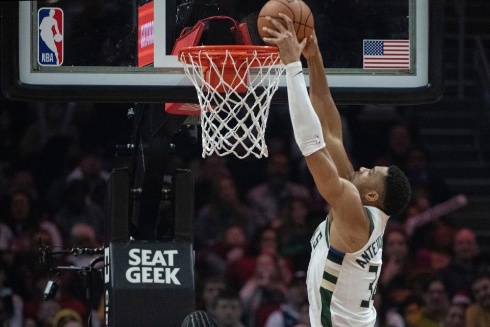 Milwaukee Bucks' Giannis Antetokounmpo (34) dunks the ball against the Cleveland Cavaliers during the first half of an NBA basketball game in Cleveland, Friday, Dec. 29, 2023. (AP Photo/Phil Long)