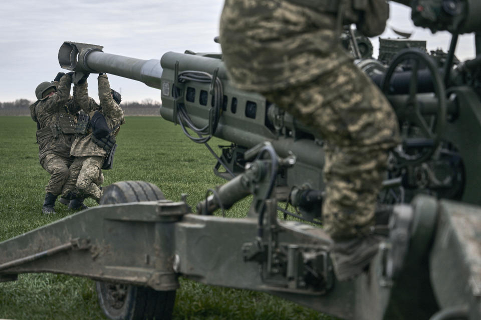 FILE - Ukrainian soldiers prepare a U.S.-supplied M777 howitzer to fire at Russian positions in Kherson region, Ukraine, Jan. 9, 2023. A rapidly expanding group of U.S. and allied troops and contractors are using phones and tablets to communicate in encrypted chat rooms to provide real-time maintenance advice to Ukrainian troops on the battlefield. As the U.S. and other allies provide a growing number of increasingly complex and high-tech weapons, the maintenance demands are expanding. (AP Photo/Libkos, File)