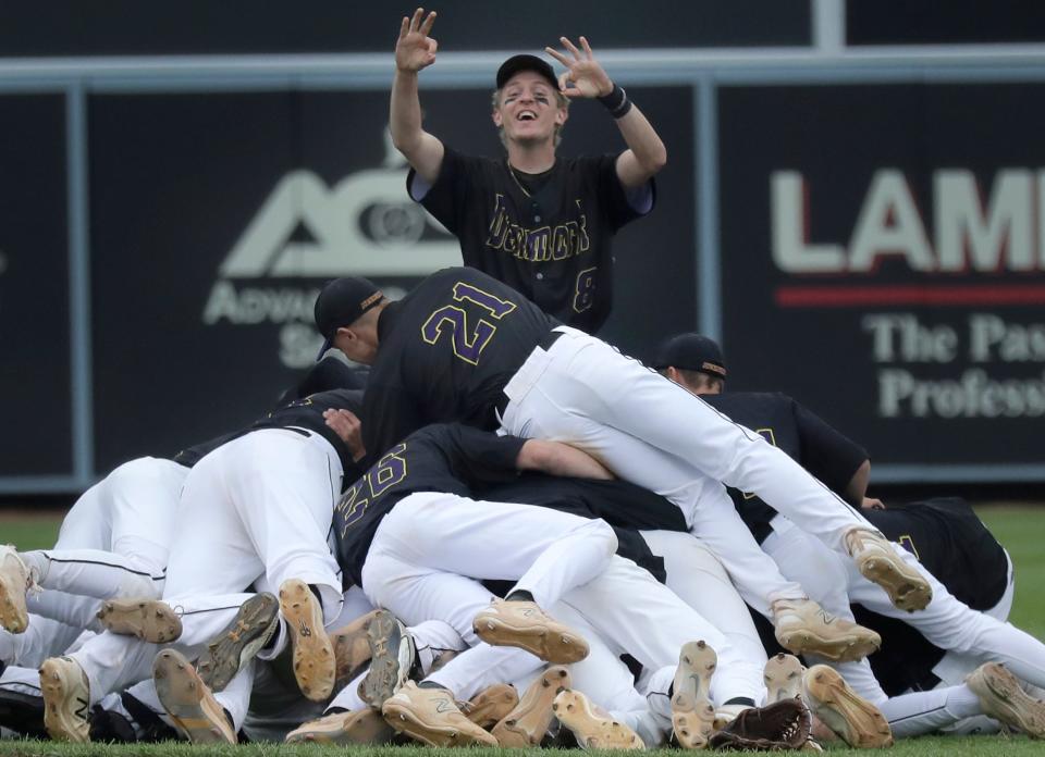 Denmark players react to their team's 3-2 victory over St. Thomas More, 3-2, in 11 innings in June at Fox Cities Stadium. It was the third consecutive state title for the Vikings.