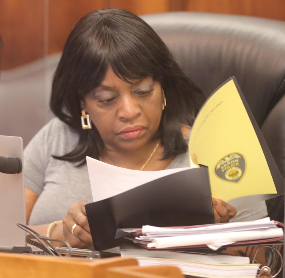 Police Oversight Board member Donzella Anuszkiewicz reads over materials distributed during the group's first meeting Friday in Akron City Council Chambers.