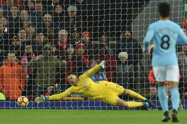 Manchester City's goalkeeper Ederson (L) dives but fails to stop Liverpool's midfielder Alex Oxlade-Chamberlain's shot for the opening goal on January 14, 2018