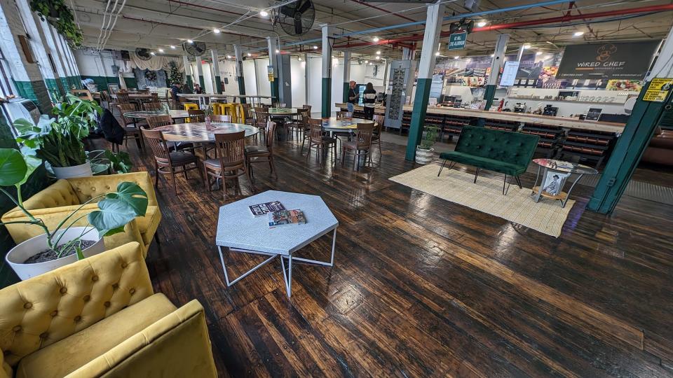 A comfortable lounge area and tables for seating in front of the Wired Chef.