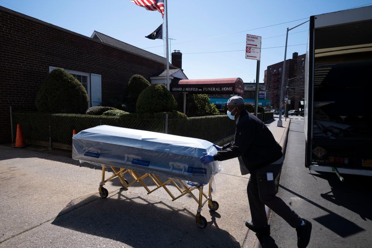 FILE - In this Friday, March 27, 2020 file photo, William Samuels delivers caskets to the Gerard Neufeld Funeral Home during the coronavirus pandemic in the Queens borough of New York. 