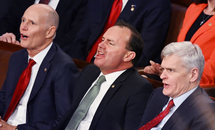 (L-R) US Senators Rick Scott (R-FL), Mike Lee (R-UT) and Bill Cassidy (R-LA) yell as US President Joe Biden delivers the State of the Union address at the US Capitol in Washington, DC, February 7, 2023. (Photo by ANDREW CABALLERO-REYNOLDS / AFP) (Photo by ANDREW CABALLERO-REYNOLDS/AFP via Getty Images)