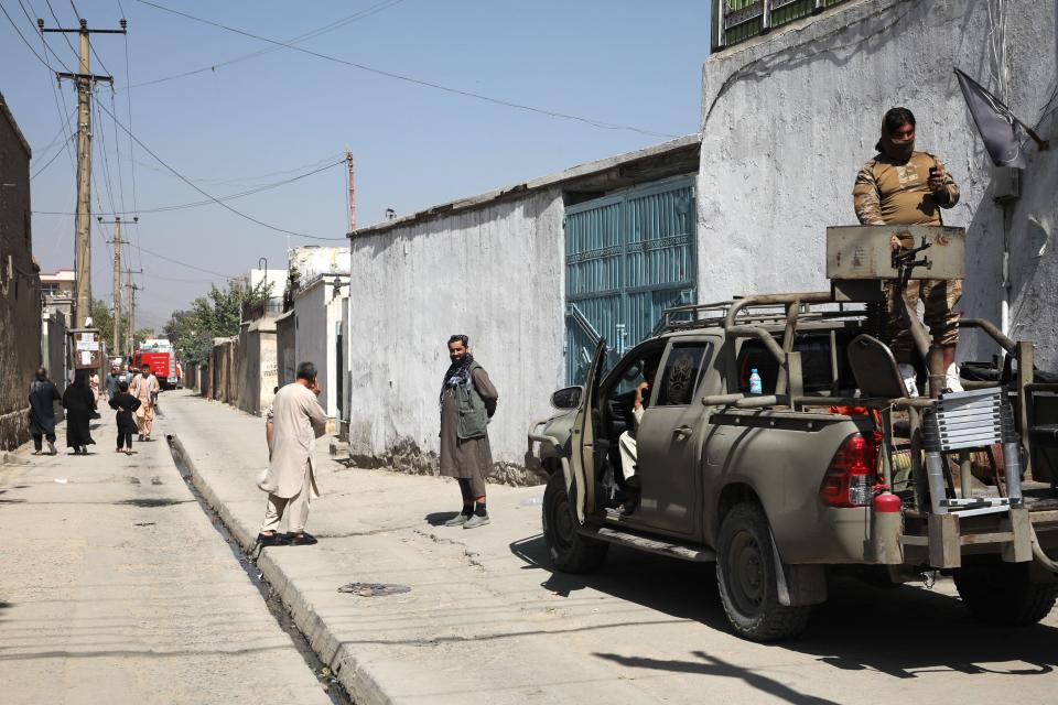 Taliban fighters stand guard near the site of suicide bomb attack at a learning center in the Dasht-e-Barchi area of Kabul, Afghanistan, September 30, 2022. / Credit: STR/AFP/Getty