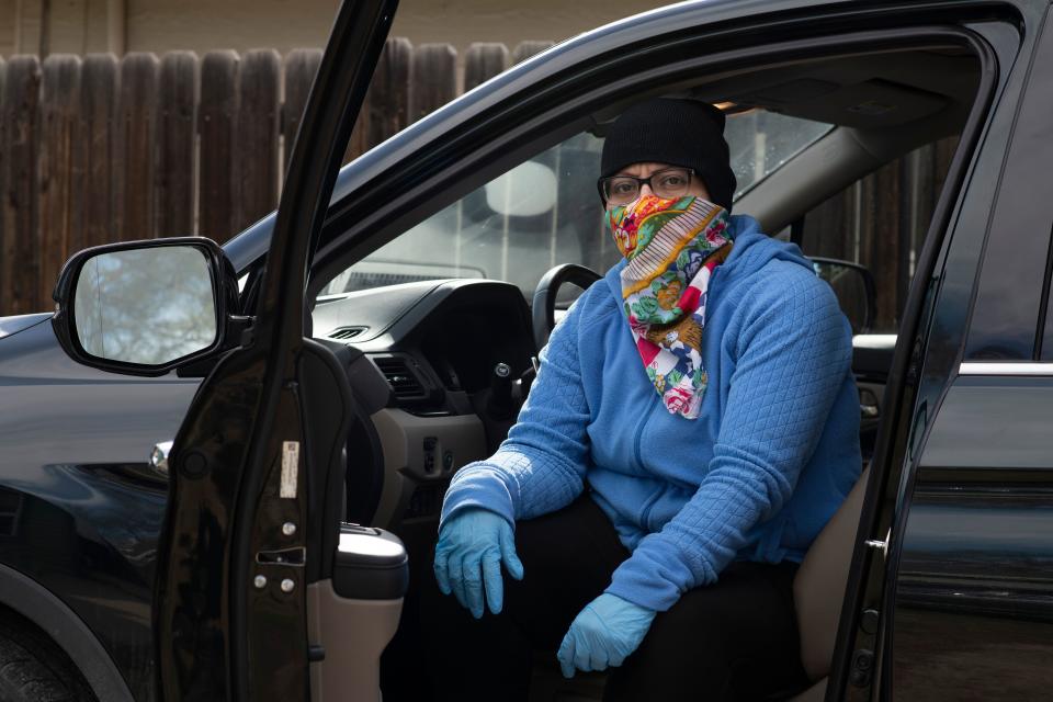 Dominguez poses in her deep cleaning outfit on March 30, 2020, at her house in Denver. (Rachel Woolf for HuffPost)