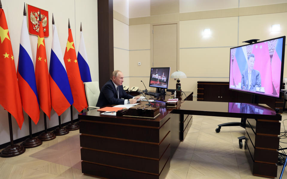 Russian President Vladimir Putin speaks with Chinese President Xi Jinping, right on the screen, via videoconference in Moscow, Russia, Wednesday, Dec. 15, 2021. Russian President Vladimir Putin and Chinese leader Xi Jinping have held a video call to discuss bilateral relations and international affairs. The summit Wednesday comes amid heightened tensions between Moscow and the West over a Russian troop buildup near Ukrainian borders that is stoking fears of a possible invasion. (Mikhail Metzel, Sputnik, Kremlin Pool Photo via AP)