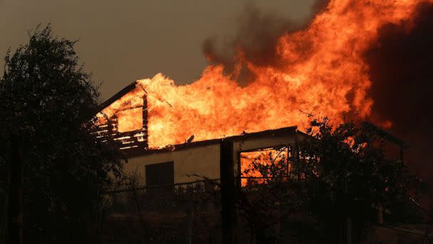 PHOTO: A residence is seen on fire in Santa Juana, near Concepcion, Chile, Feb. 3, 2023. (Juan Gonzalez/Reuters)