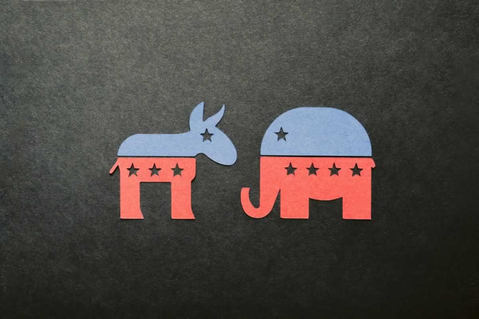 The symbols of the Democratic and Republican parties on a black background. Image by Kelly Sikkema via Unsplash.