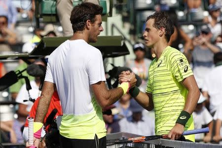 Mar 26, 2015; Key Biscayne, FL, USA; Vasek Pospisil (R) shakes hands with Juan Martin Del Potro (L) on day three of the Miami Open at Crandon Park Tennis Center. Pospisil won 6-4, 7-6 (7). Mandatory Credit: Geoff Burke-USA TODAY