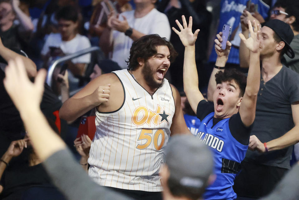 Fans react during an NBA basketball draft watch party in Orlando, Fla., after the Orlando Magic selected Duke's Paolo Banchero with the first pick in the draft Thursday, June 23, 2022. (Stephen M. Dowell/Orlando Sentinel via AP)