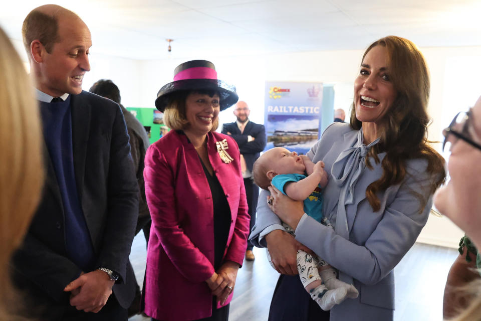 <p>Kate also held a baby at Carrick Connect — and she's admitted in the past to <a href="https://people.com/royals/kate-middleton-confesses-shes-very-broody-i-come-home-saying-lets-have-another-one/" rel="nofollow noopener" target="_blank" data-ylk="slk:getting "broody" around little ones;elm:context_link;itc:0;sec:content-canvas" class="link ">getting "broody" around little ones</a>!</p>