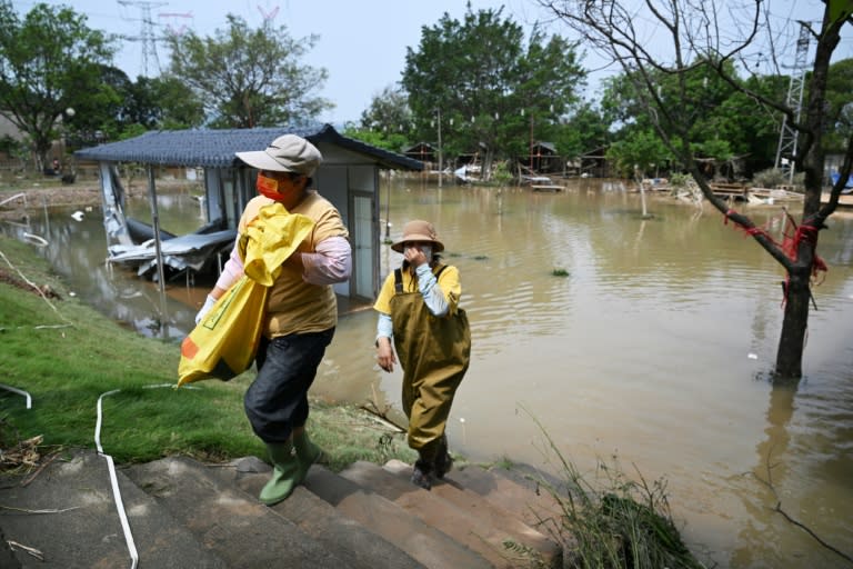 Workers cleared debris from a flooded areas (HECTOR RETAMAL)