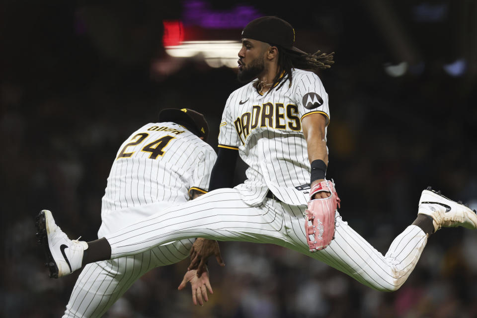 San Diego Padres' Fernando Tatis Jr., foreground, celebrates with Rougned Odor after the team's win over the Cleveland Guardians in a baseball game Tuesday, June 13, 2023, in San Diego. (AP Photo/Derrick Tuskan)